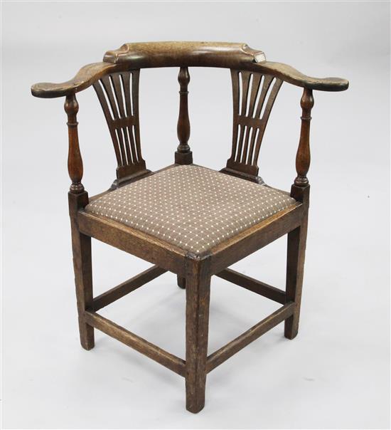 An 18th century oak corner chair,